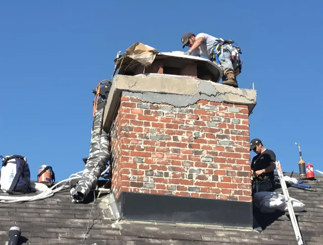 Glocester Chimney Sweep installing a custom chimney crown in Glocester, RI